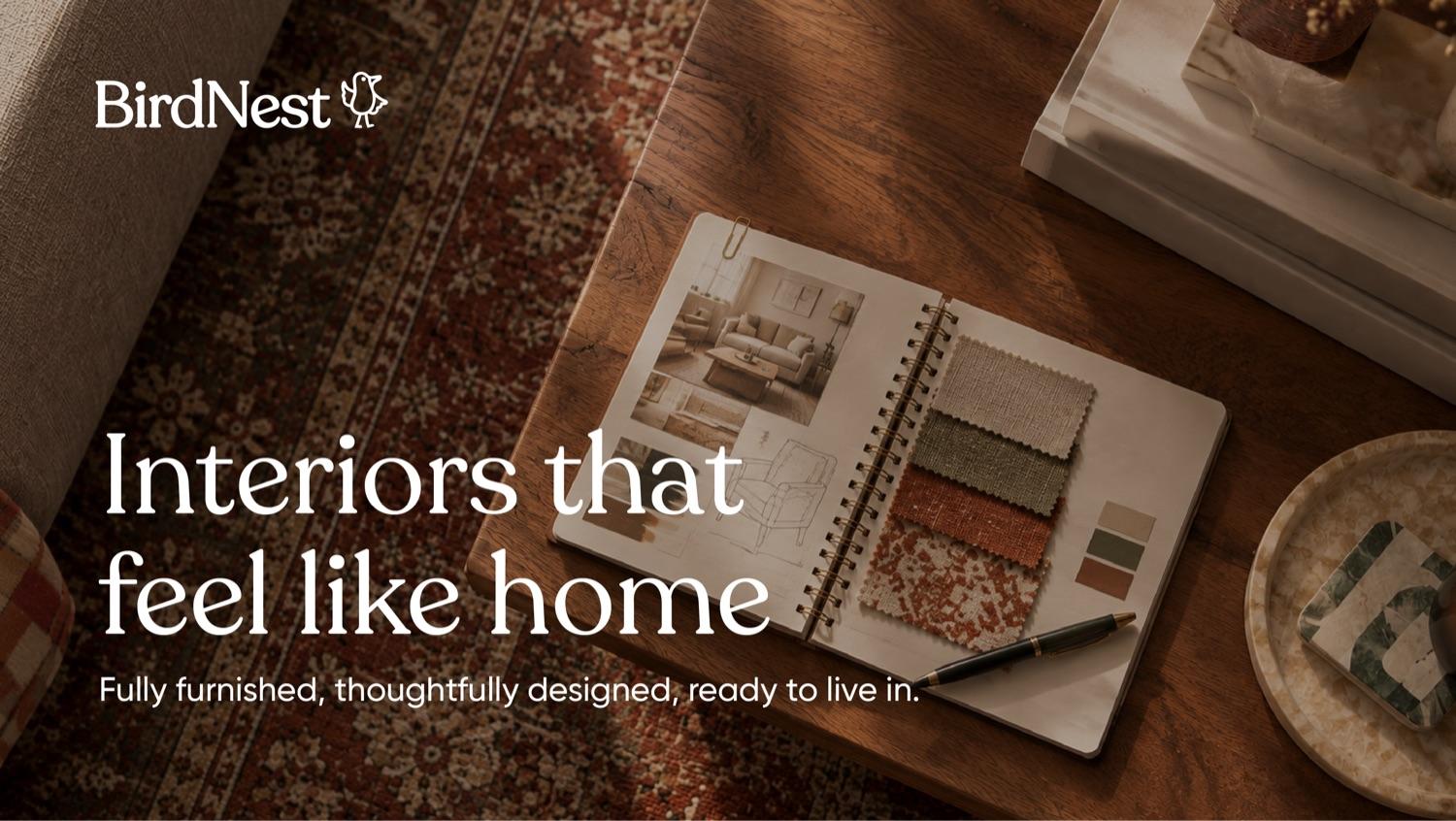 Interior design sketchbook with fabric swatches on a wooden table